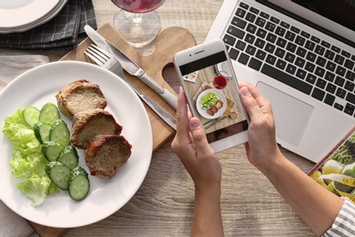 Photo of Blogger taking photo of food with mobile phone, closeup