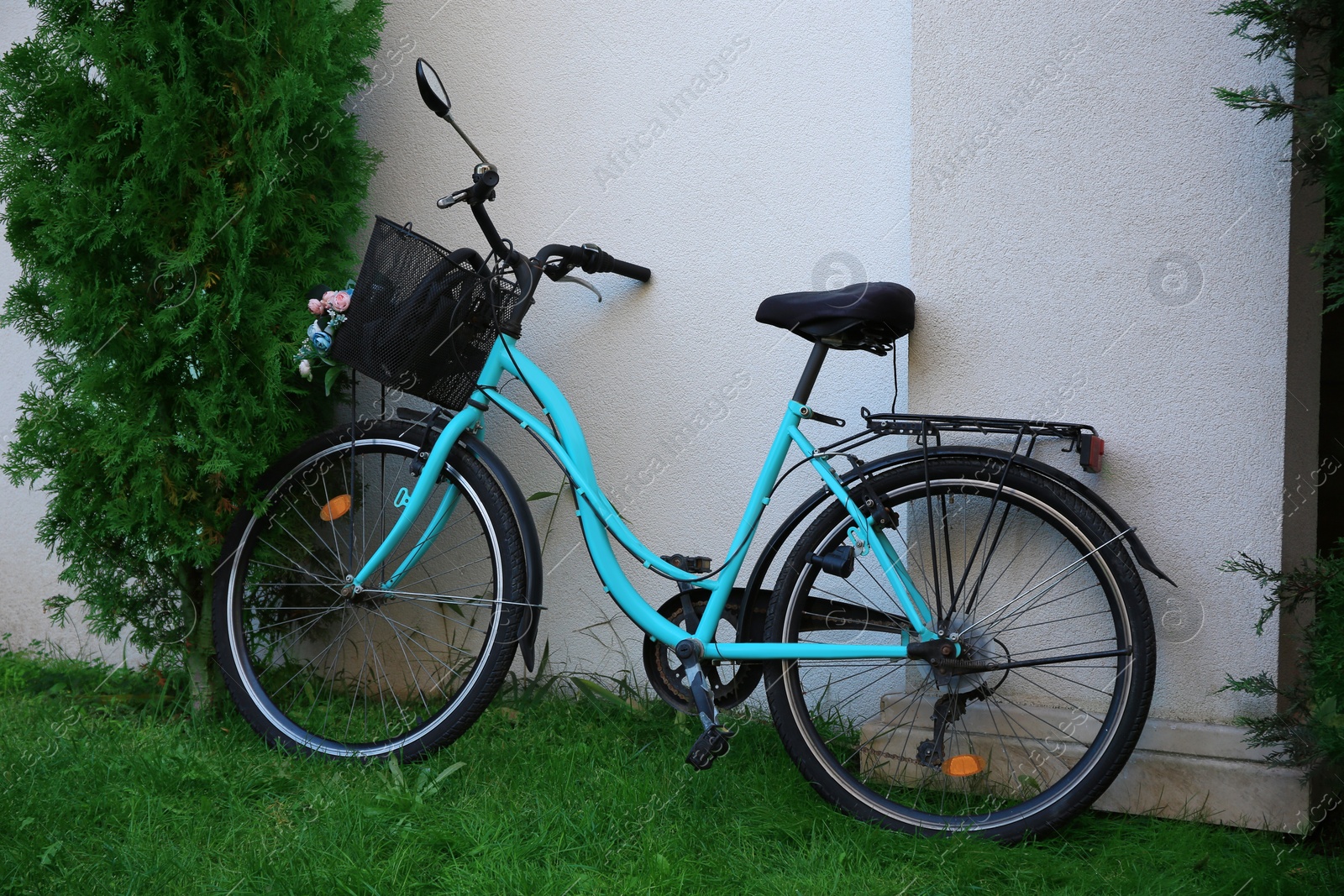 Photo of Stylish bicycle with basket near white wall outdoors