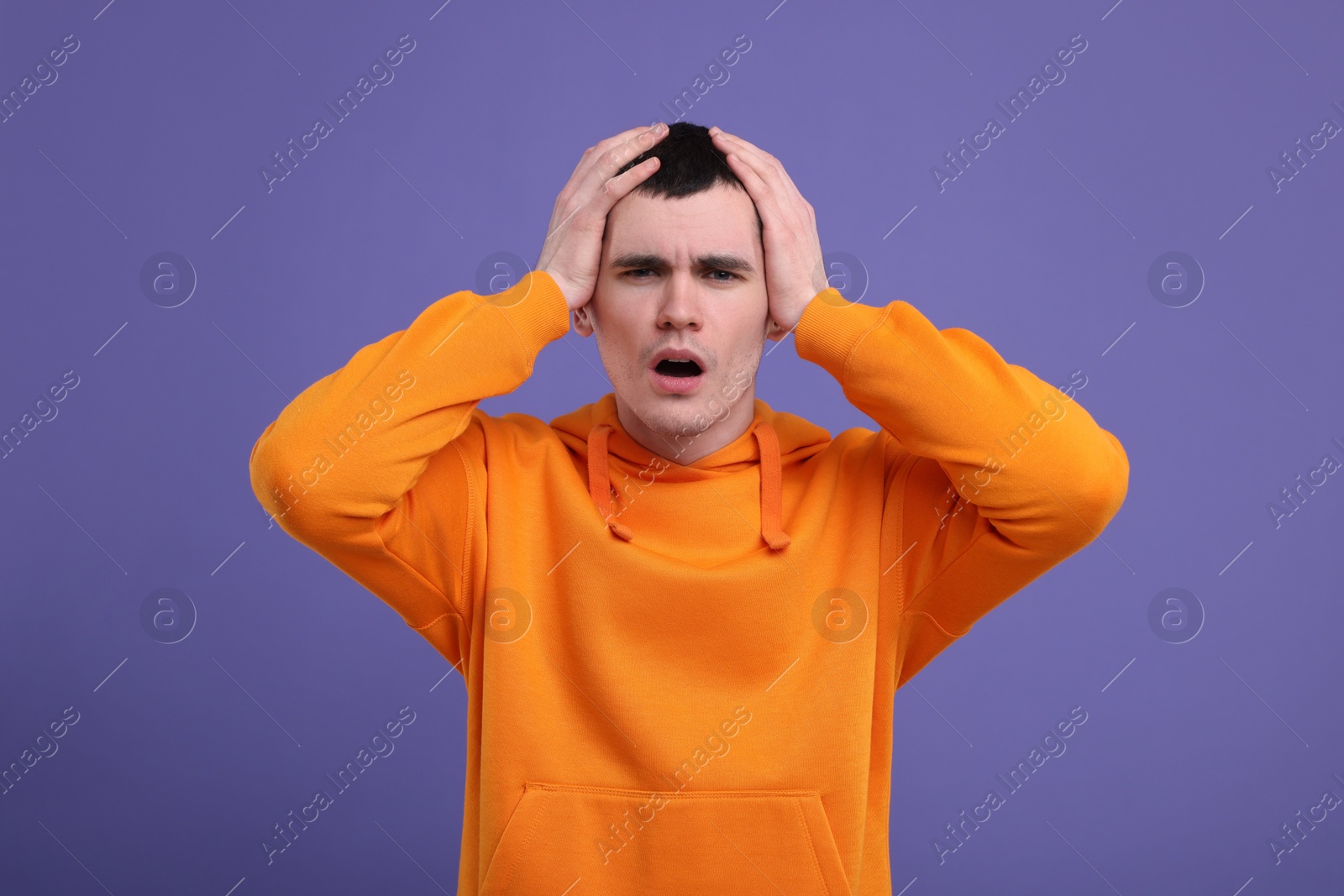 Photo of Portrait of surprised man on purple background