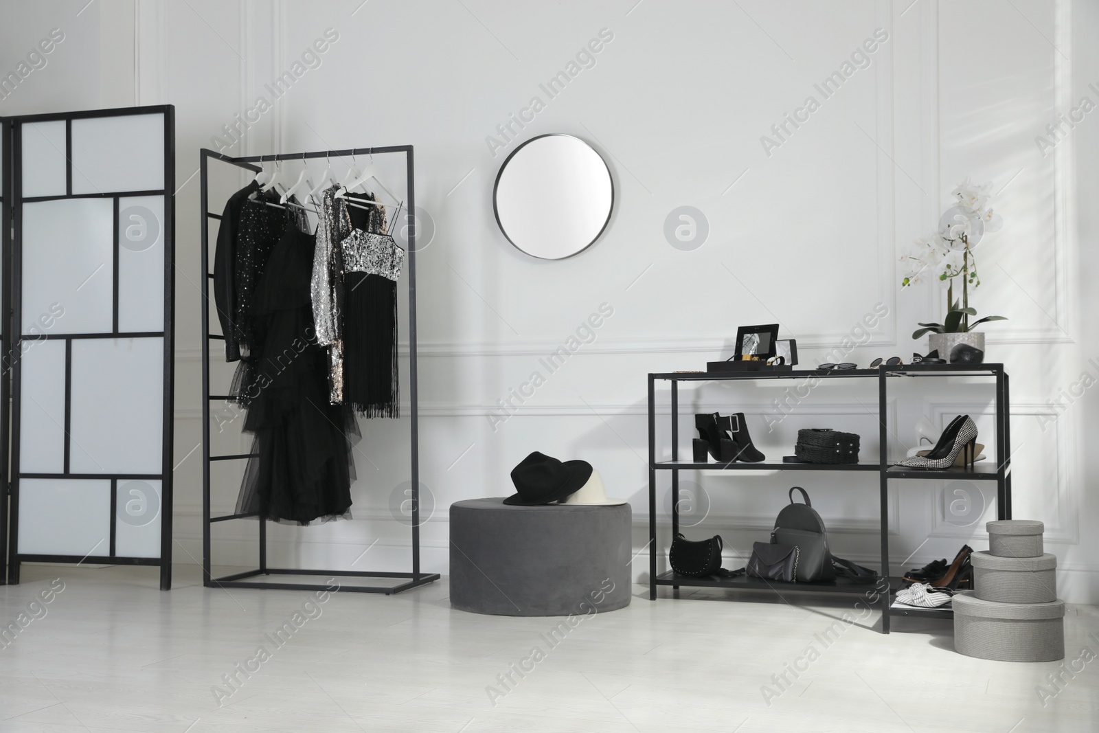 Photo of Stylish dressing room interior with trendy clothes, shoes and accessories