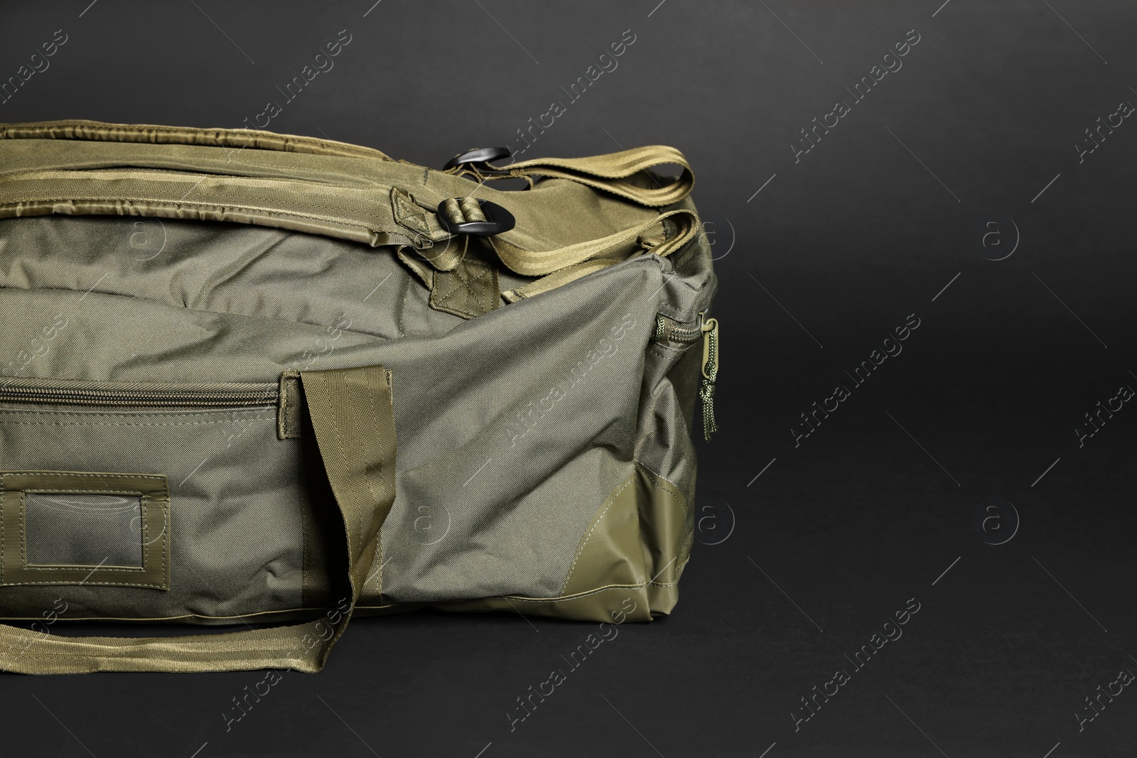 Photo of Army bag on dark grey background, space for text. Military equipment
