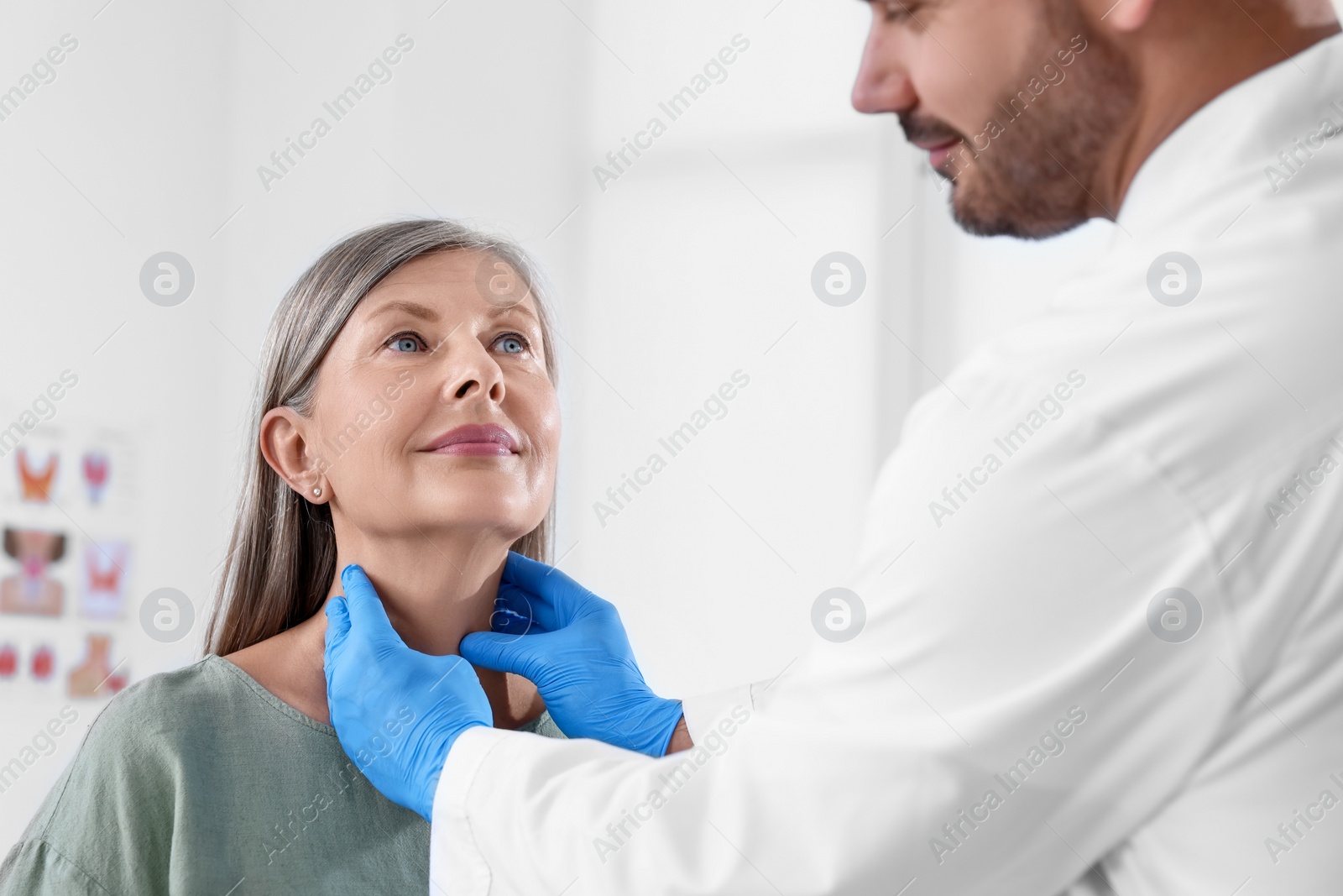 Photo of Endocrinologist examining thyroid gland of patient at hospital, closeup