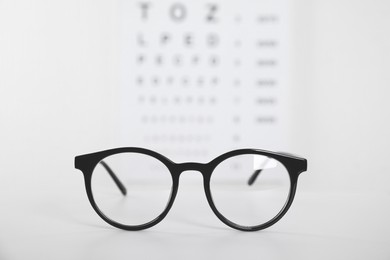 Photo of Glasses on light background, closeup. Ophthalmologist prescription