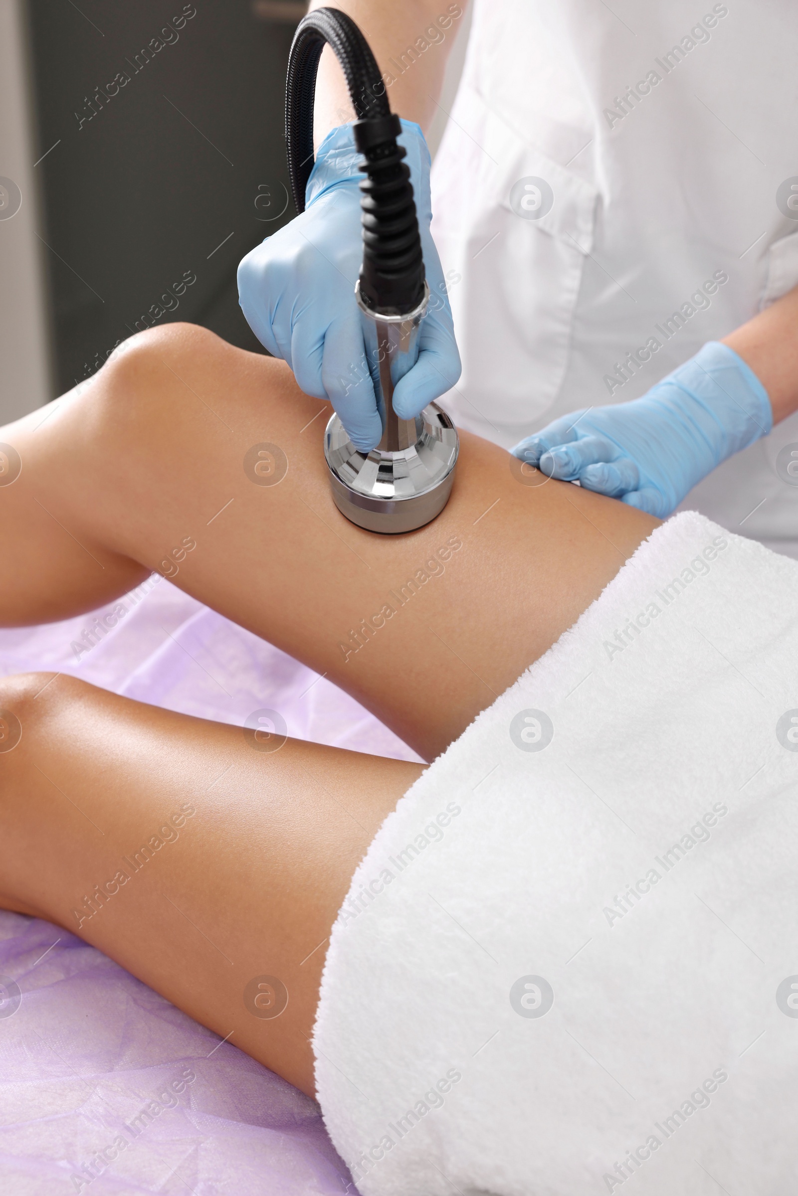 Photo of Woman undergoing radio frequency lifting procedure in beauty salon, closeup