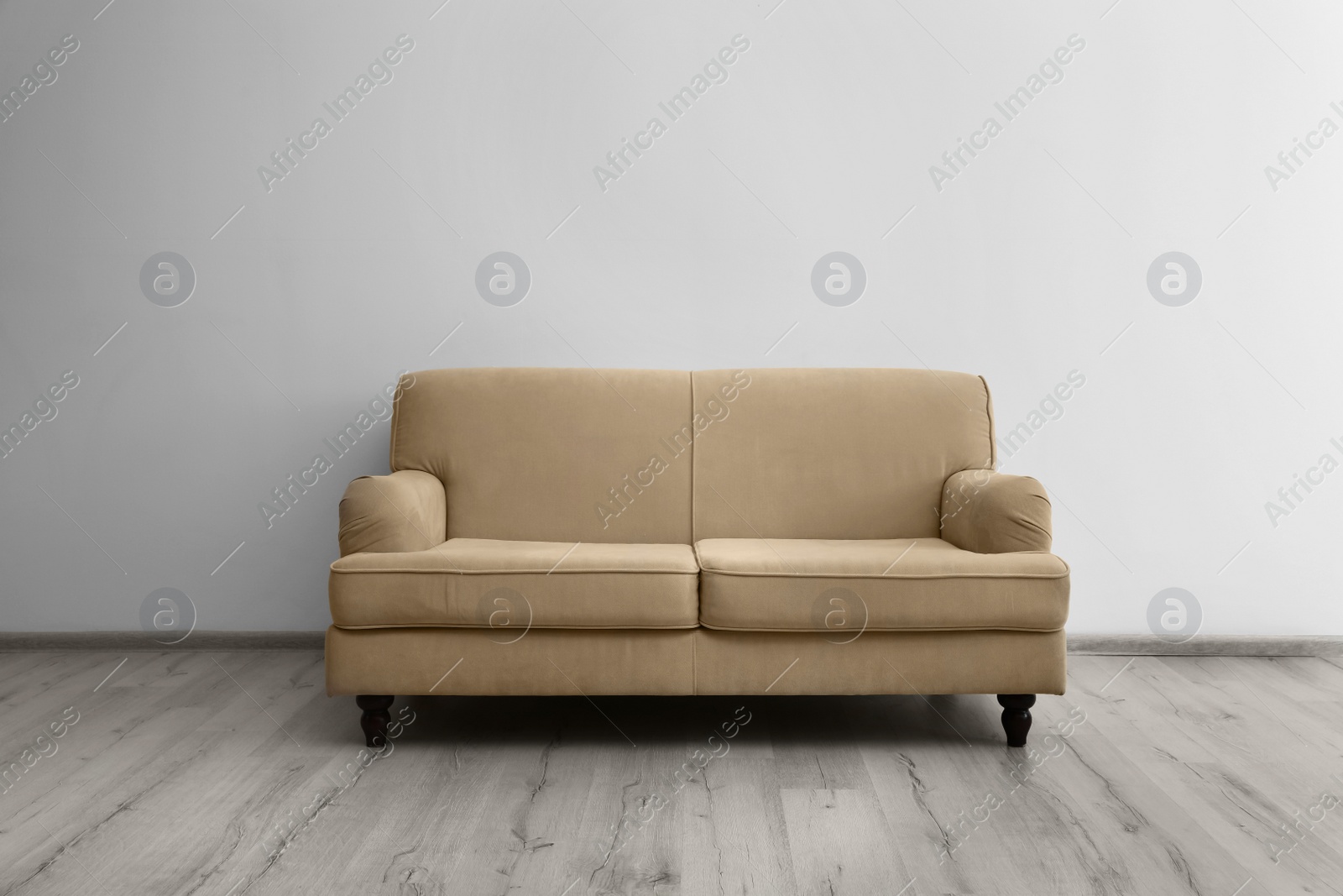 Photo of Room interior with comfortable sofa near white wall