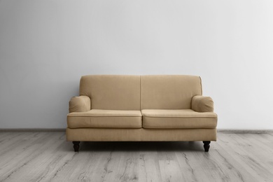 Photo of Room interior with comfortable sofa near white wall