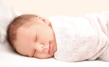 Photo of Adorable newborn baby sleeping in bed