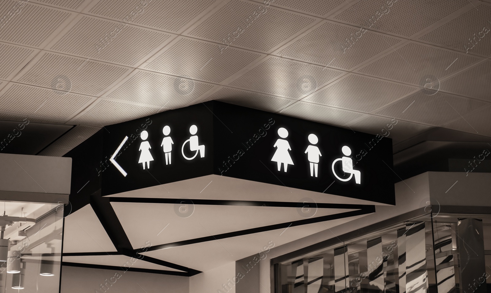Image of Symbols on black sign in mall near public toilet