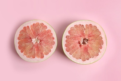 Photo of Fresh cut pomelo fruit on pink background, flat lay