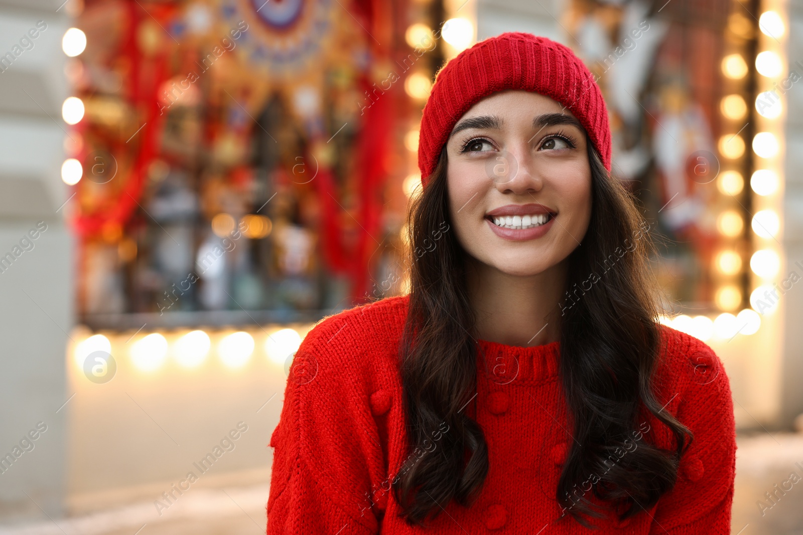 Photo of Portrait of smiling woman on blurred background, space for text. Winter time