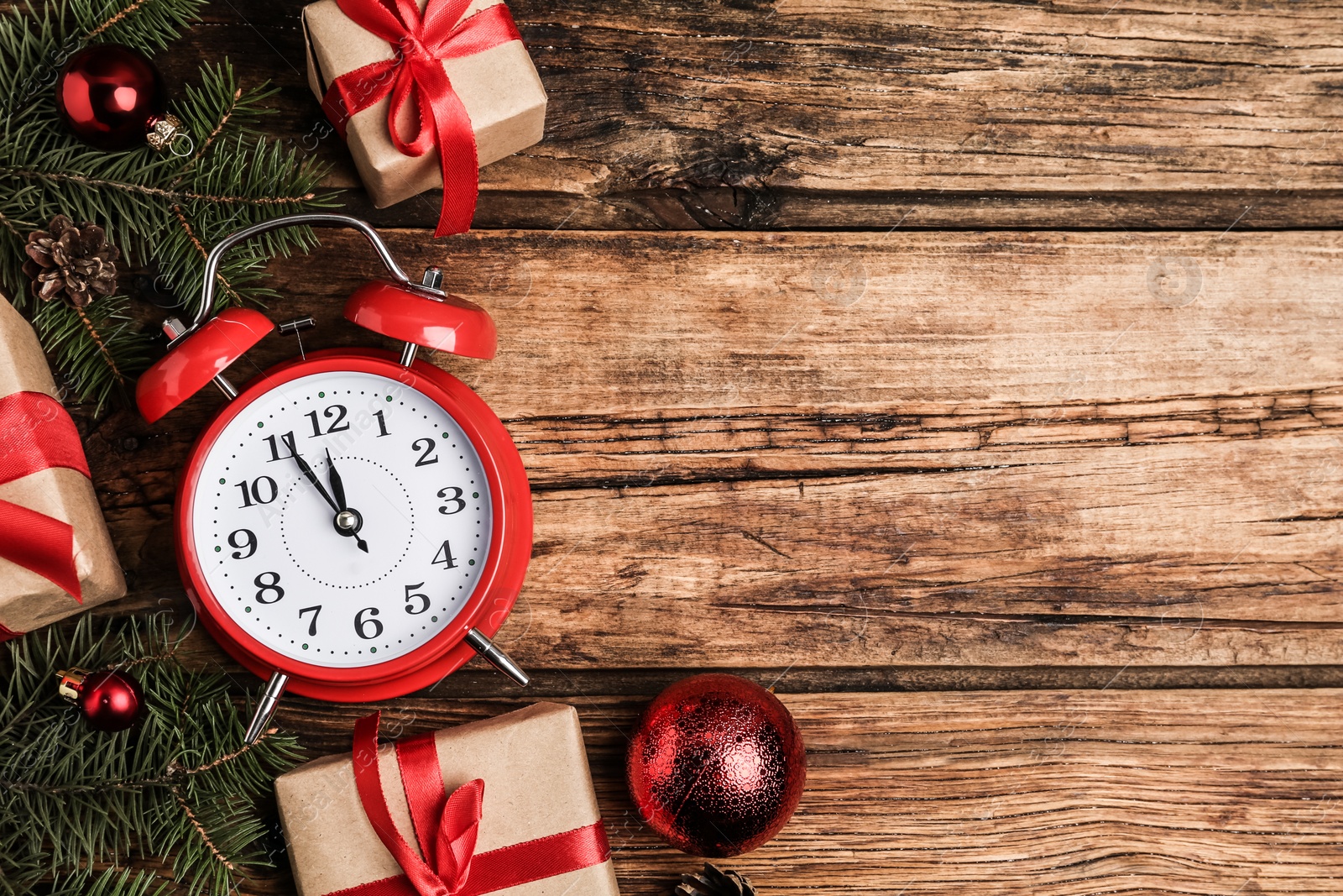 Photo of Flat lay composition with Christmas gifts and alarm clock on wooden table, space for text. Boxing day