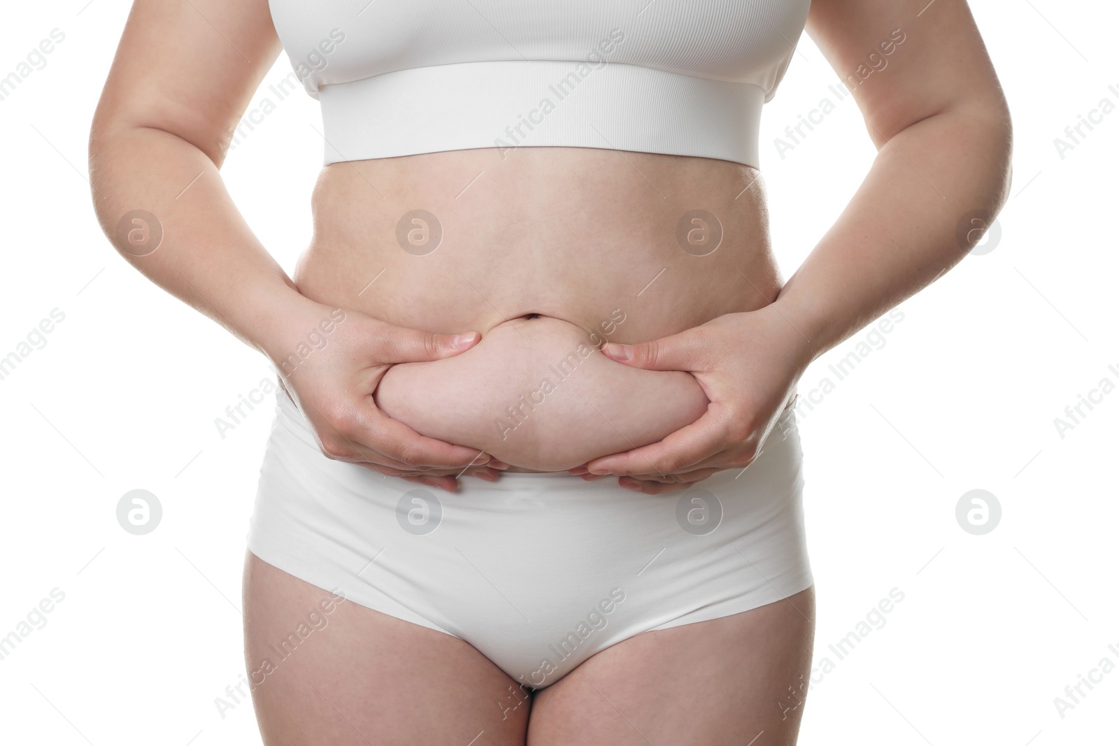 Photo of Woman touching belly fat on white background, closeup. Overweight problem