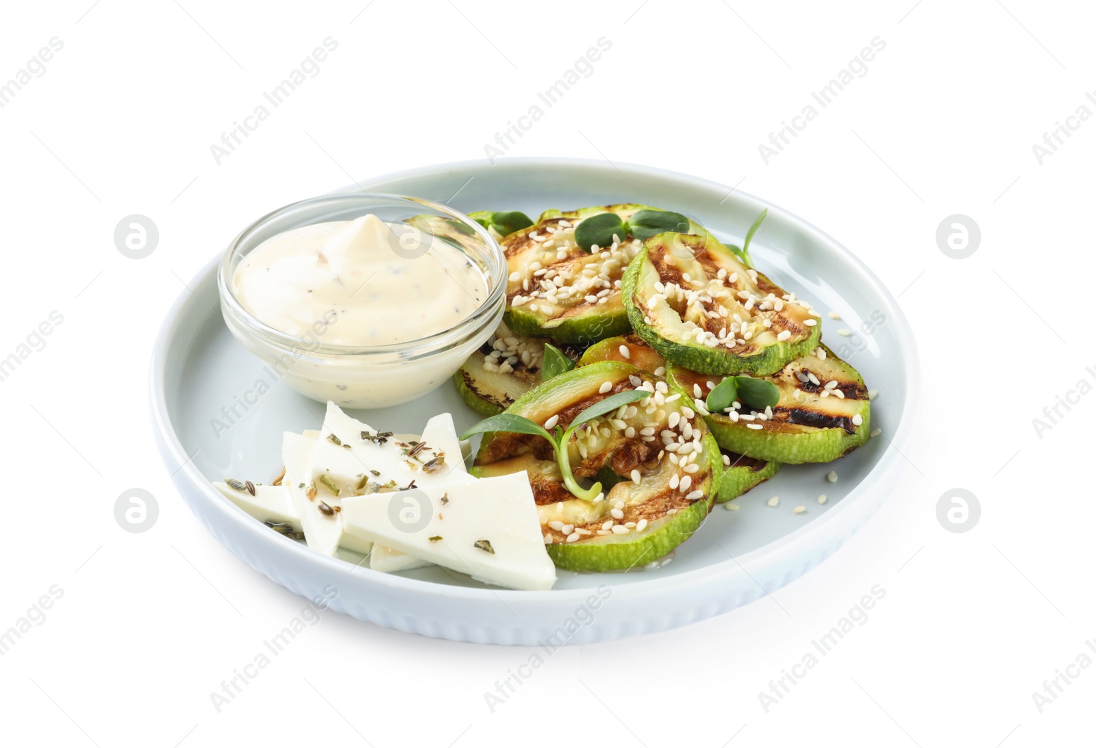 Photo of Delicious grilled zucchini slices served with sauce and cheese on white background