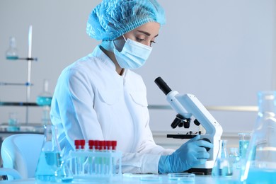 Photo of Scientist working with microscope in laboratory. Medical research