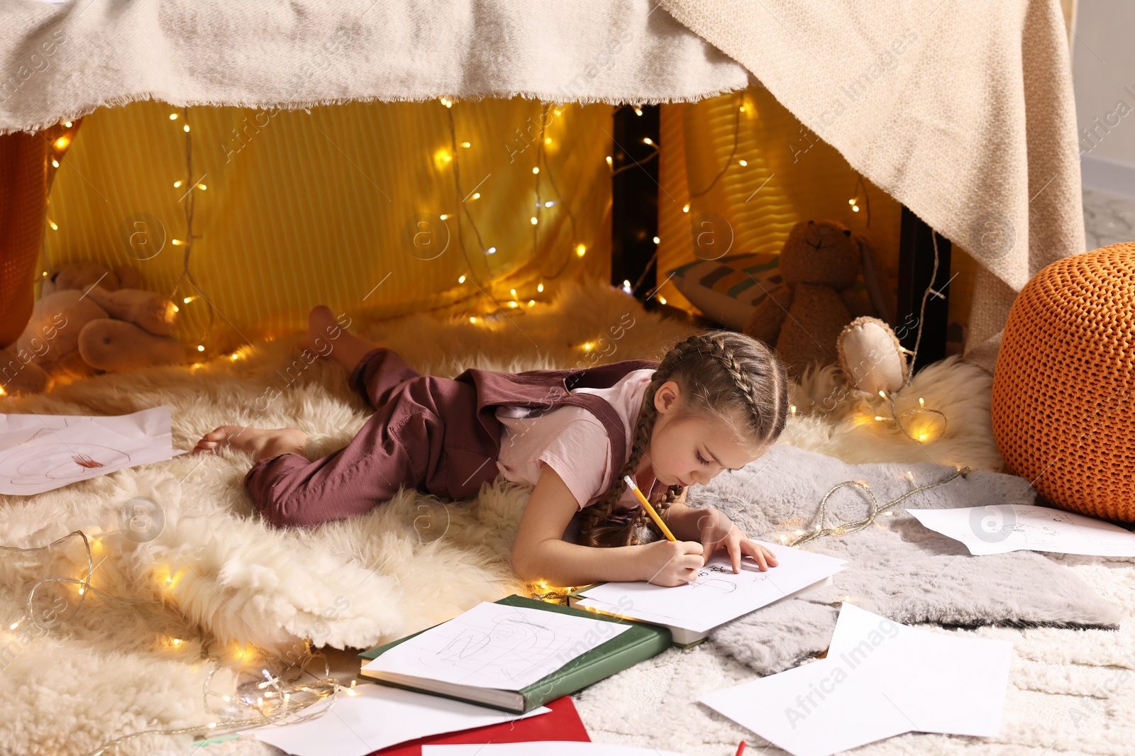 Photo of Girl drawing in play tent at home