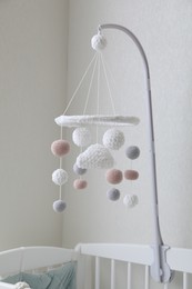 Modern baby mobile under crib in children's room