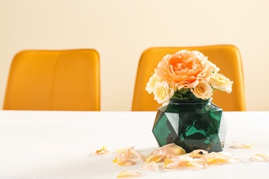 Photo of Vase with blooming flowers on table indoors