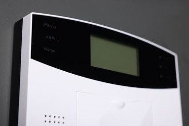 Photo of Home security alarm system on gray wall, closeup