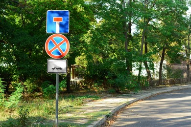 Photo of Road signs No Stopping and Dead End outdoors near trees on sunny day, space for text