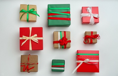 Flat lay composition with Christmas gift boxes on light background