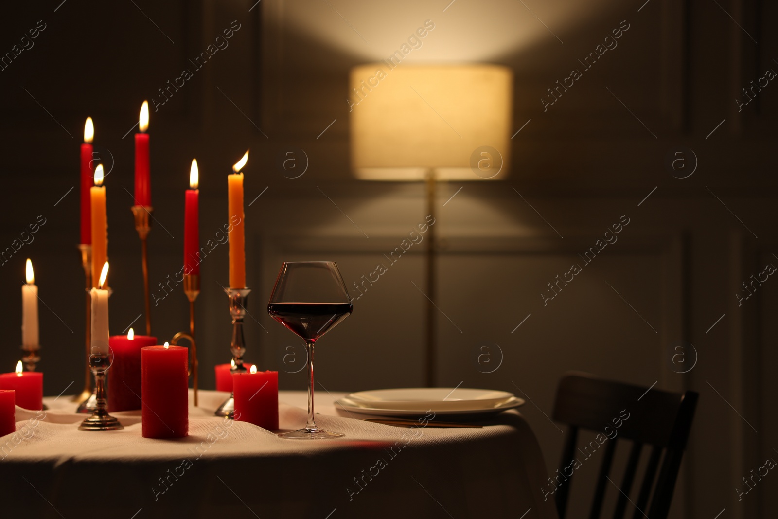 Photo of Elegant table setting with burning candles in restaurant