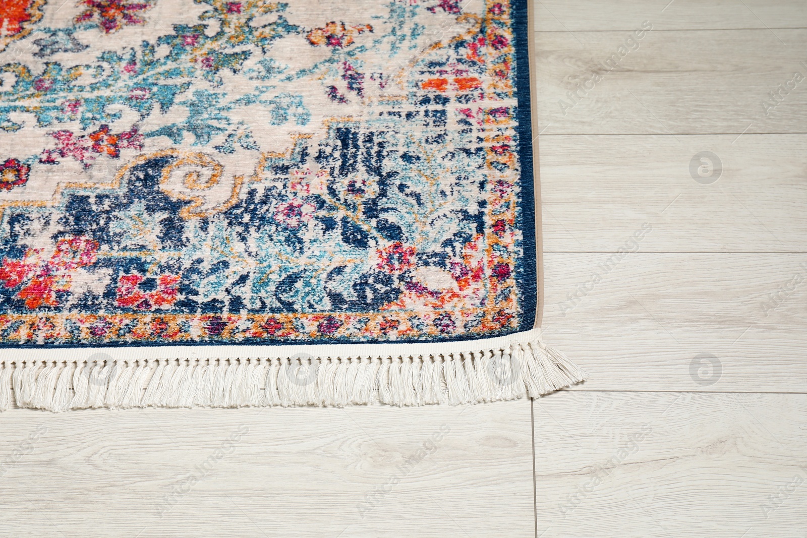 Photo of Soft carpet with pattern on white laminated floor indoors, top view. Space for text