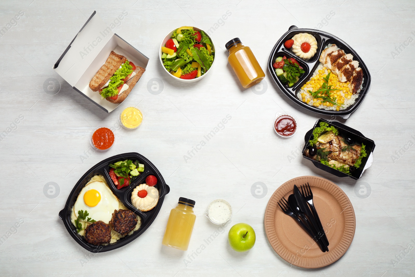 Photo of Frame made of lunchboxes on white table, top view with space for text. Healthy food delivery