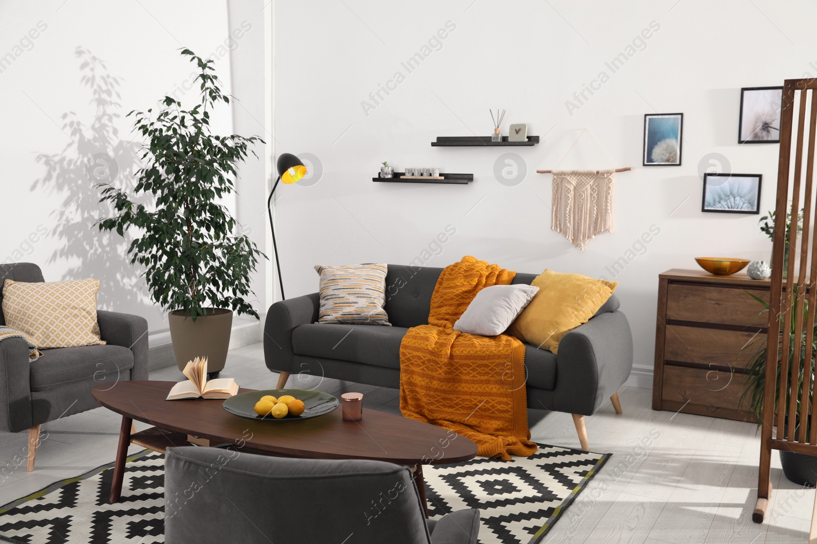 Photo of Stylish living room interior with comfortable sofa and wooden table