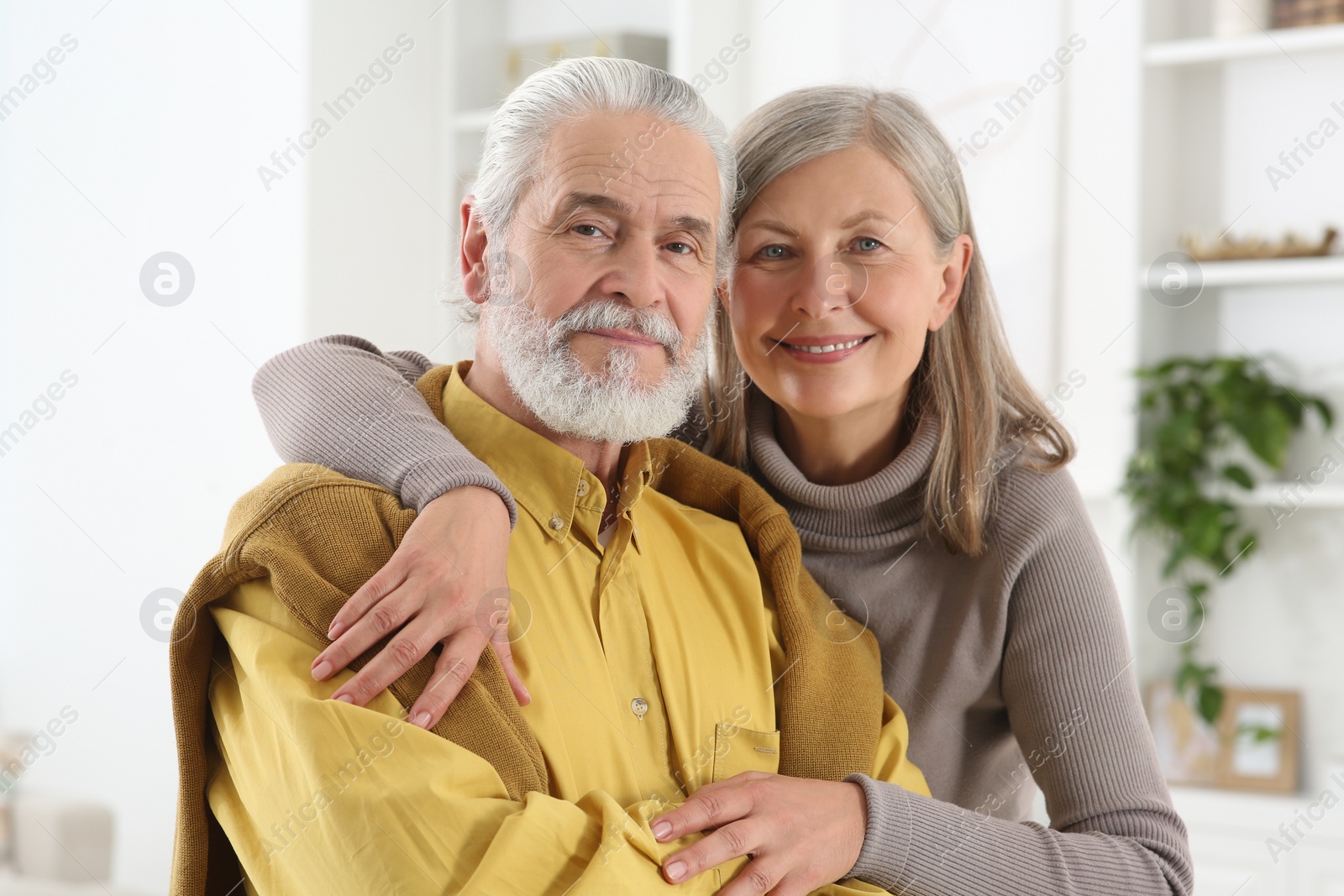 Photo of Portrait of affectionate senior couple at home