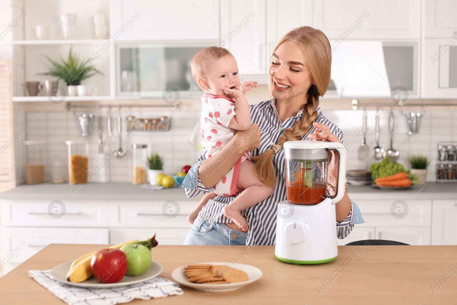 Photo of Woman preparing breakfast for her child in kitchen. Healthy baby food