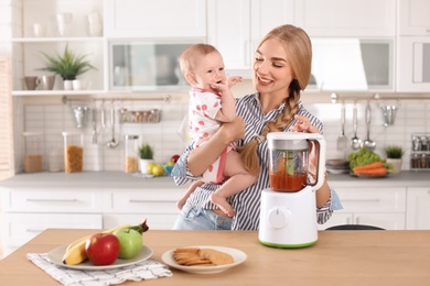 Photo of Woman preparing breakfast for her child in kitchen. Healthy baby food