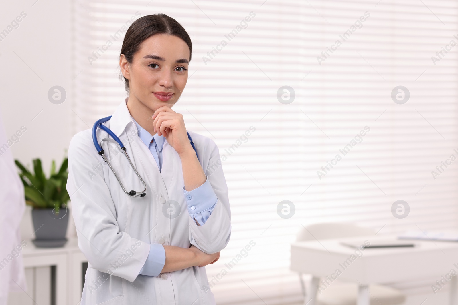 Photo of Medical consultant with stethoscope in clinic, space for text