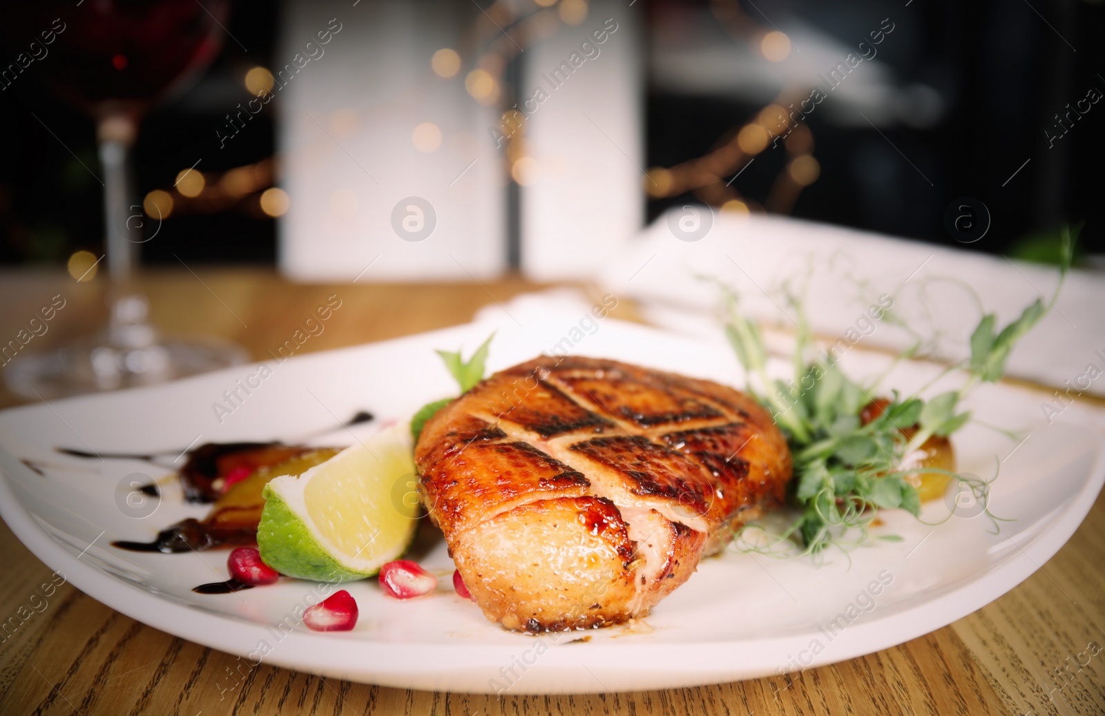 Image of Delicious grilled duck breast served on wooden table indoors, closeup. Food photography  