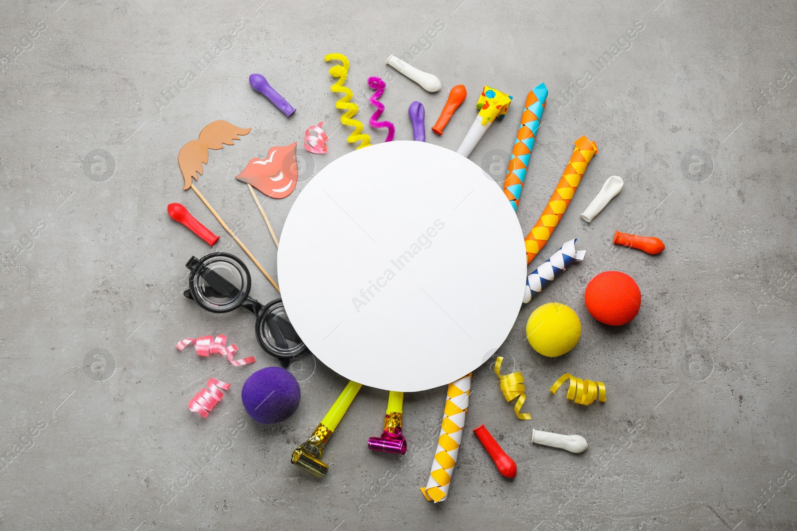 Photo of Flat lay composition with carnival items and blank card on grey background. Space for text