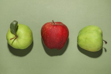 Photo of Tasty fresh apples on green background, flat lay