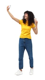 Beautiful young woman taking selfie on white background