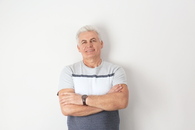 Portrait of handsome mature man on light background