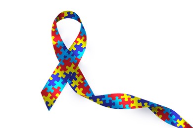 World Autism Awareness Day. Colorful puzzle ribbon on white background, top view