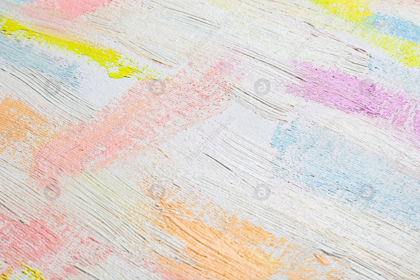 Photo of Strokes of different pastel acrylic paints on white canvas, closeup