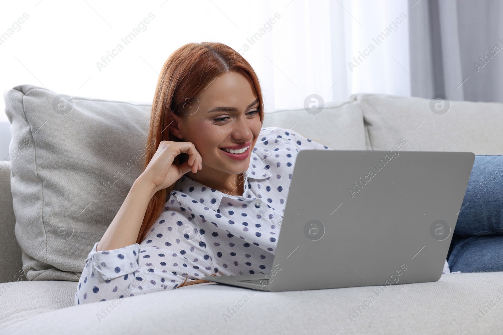 Photo of Woman having video chat via laptop at home