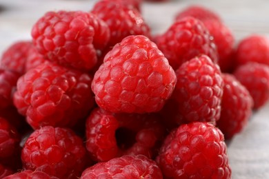 Heap of tasty ripe raspberries on table, closeup