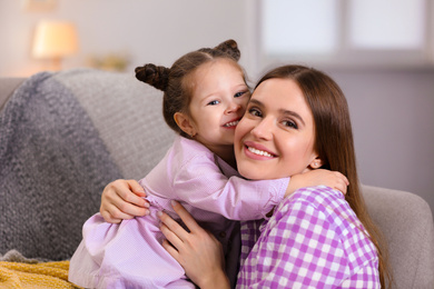 Photo of Young mother with little daughter at home