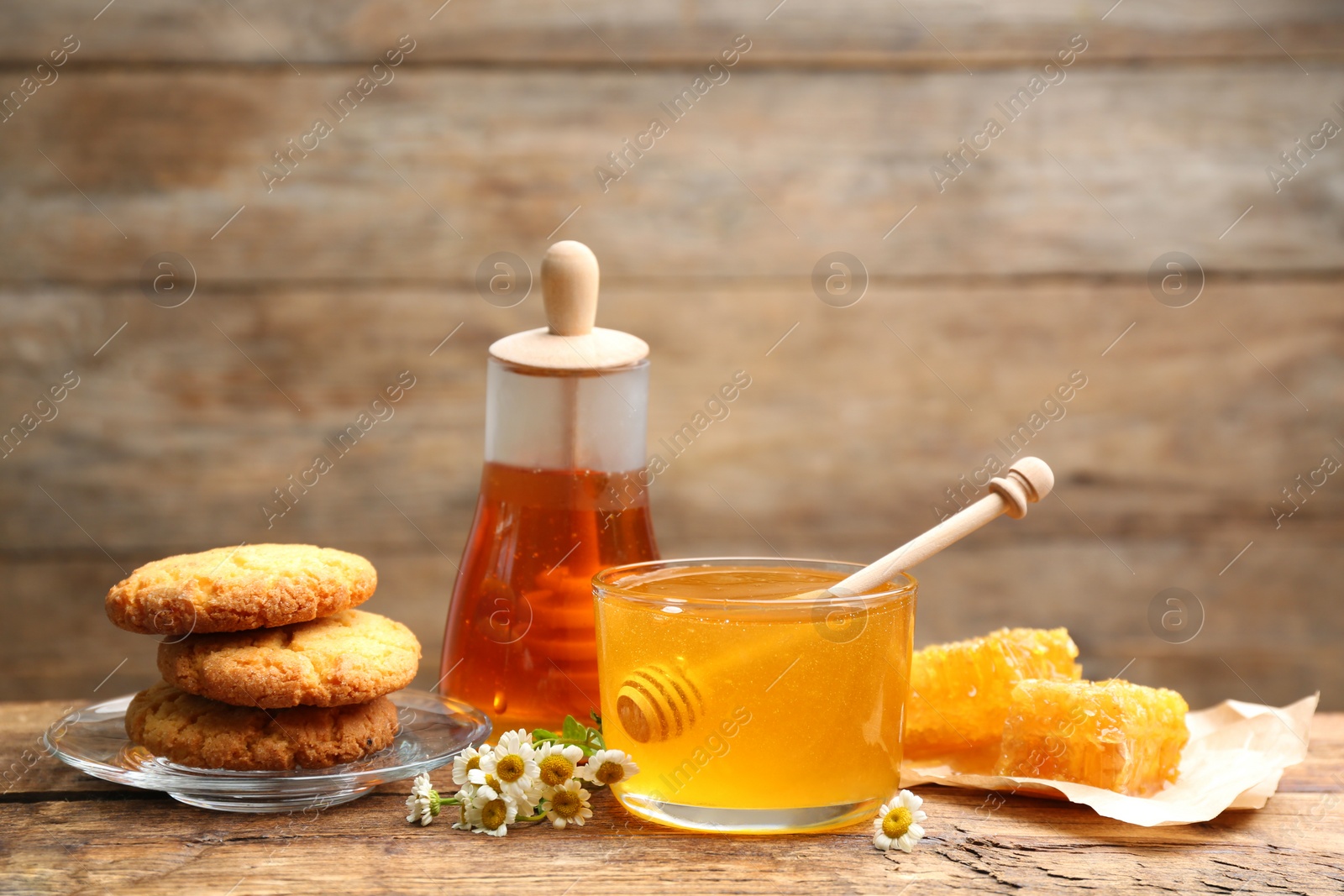 Photo of Composition with tasty honey on wooden table