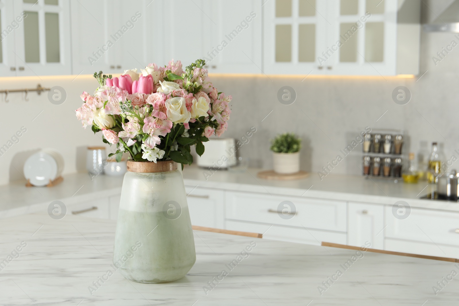 Photo of Beautiful bouquet of fresh flowers in vase on table indoors, space for text