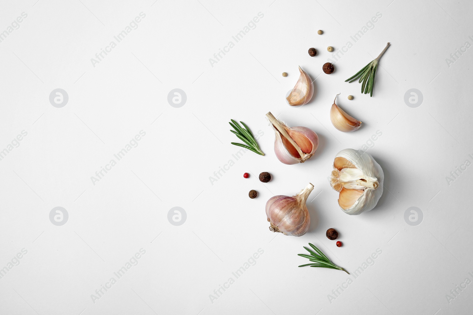 Photo of Composition with garlic, pepper and rosemary on white background, top view. Space for text