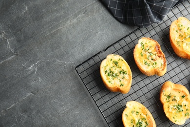 Photo of Flat lay composition with tasty homemade garlic bread and space for text on table