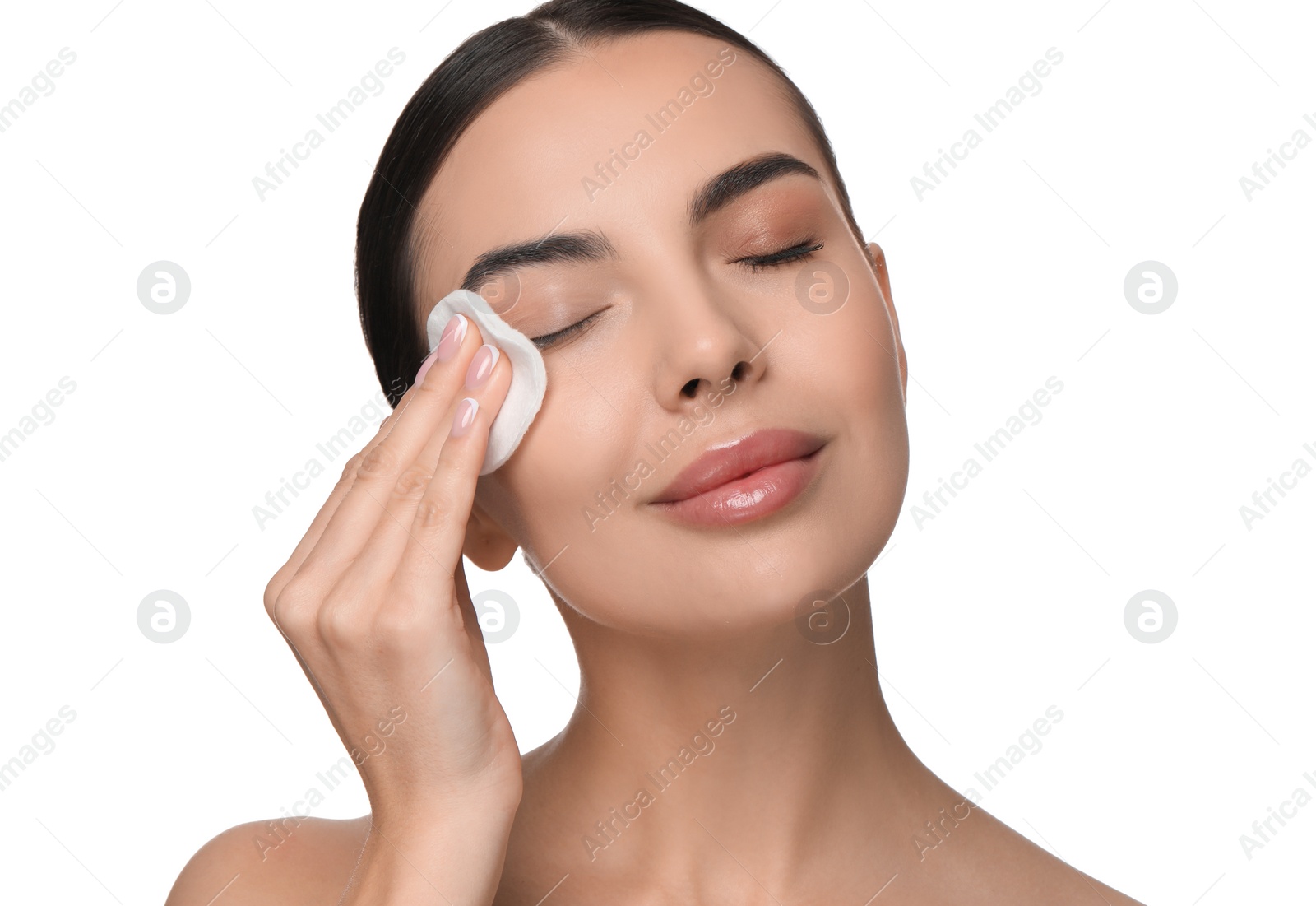 Photo of Beautiful woman removing makeup with cotton pad on white background