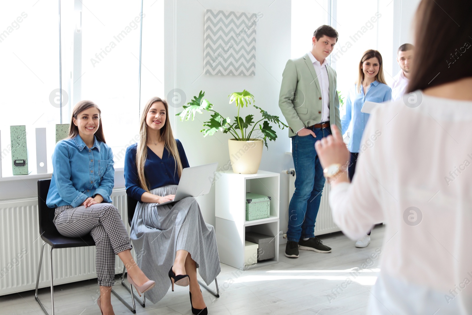 Photo of Young people having business training in office