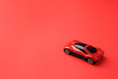 Photo of One bright car on red background. Space for text