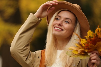 Photo of Portrait of happy woman with autumn leaves outdoors